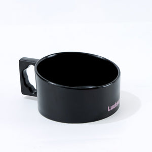 A glossy black ceramic mug with a square handle featuring a cutout, shown on a white background. The side of the mug has a small pink printed text that reads 'Luitens' at Pet Servo