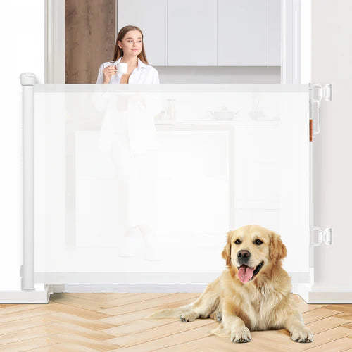 Woman standing behind a white pet gate with a dog sitting on the floor at Pet Servo