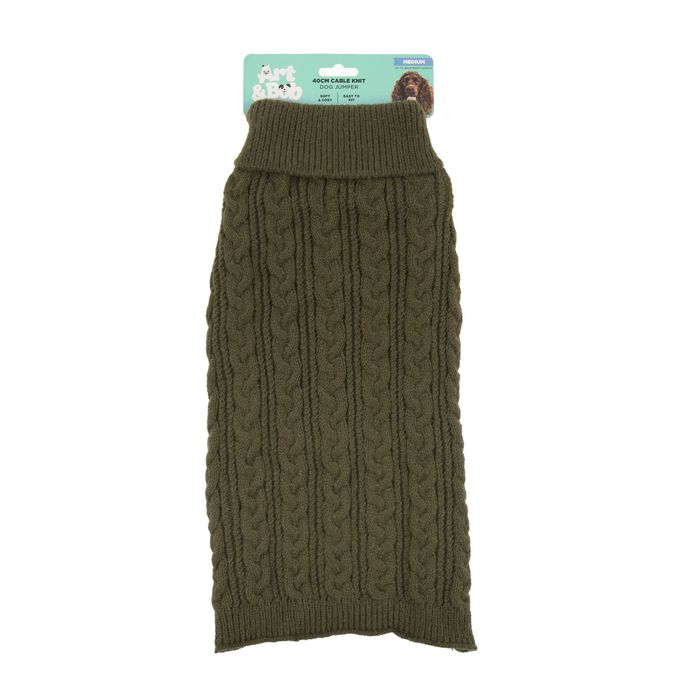 Green knitted dog sweater with packaging on a white background