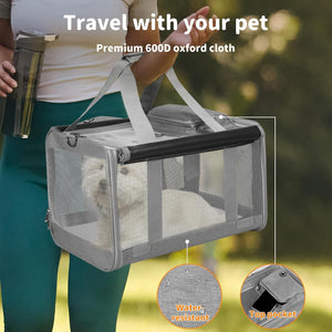 A gray mesh pet carrier bag with black trim and white handles, shown being carried outdoors by a person. A small white dog is visible inside the bag at Pet Servo
