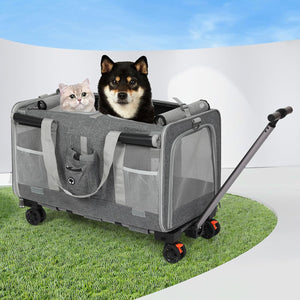 A gray pet stroller with mesh sides and four wheels, shown on a grass-like surface with a white curved backdrop. A black-and-tan dog sits inside the stroller, and a light-colored cat rests on the left side at Pet Servo