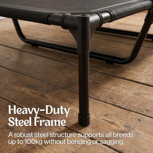 Heavy-duty steel frame of a pet bed on a wooden floor with text highlighting its strength at Pet Servo