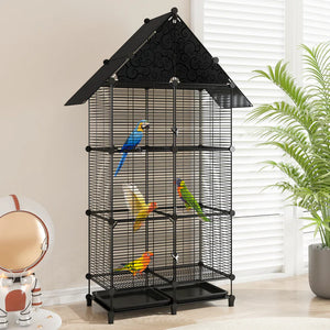 Black bird cage with colorful parrots inside, placed indoors near a plant and decorative items.