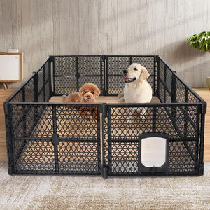 A black plastic modular dog playpen with a small door, set up in a room with a wood-look wall and rug. Two dogs, one golden retriever and one poodle, are inside the playpen at Pet Servo