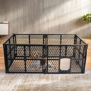 A black plastic pet playpen with a diamond-grid design and a hinged door, shown in a staged indoor room with a dog visible inside. The playpen is set on a textured rug against a wood-paneled wall at Pet Servo