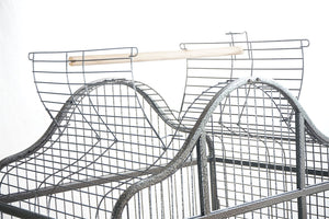 Metal wire bird cage with a white perch on a white background at Pet Servo