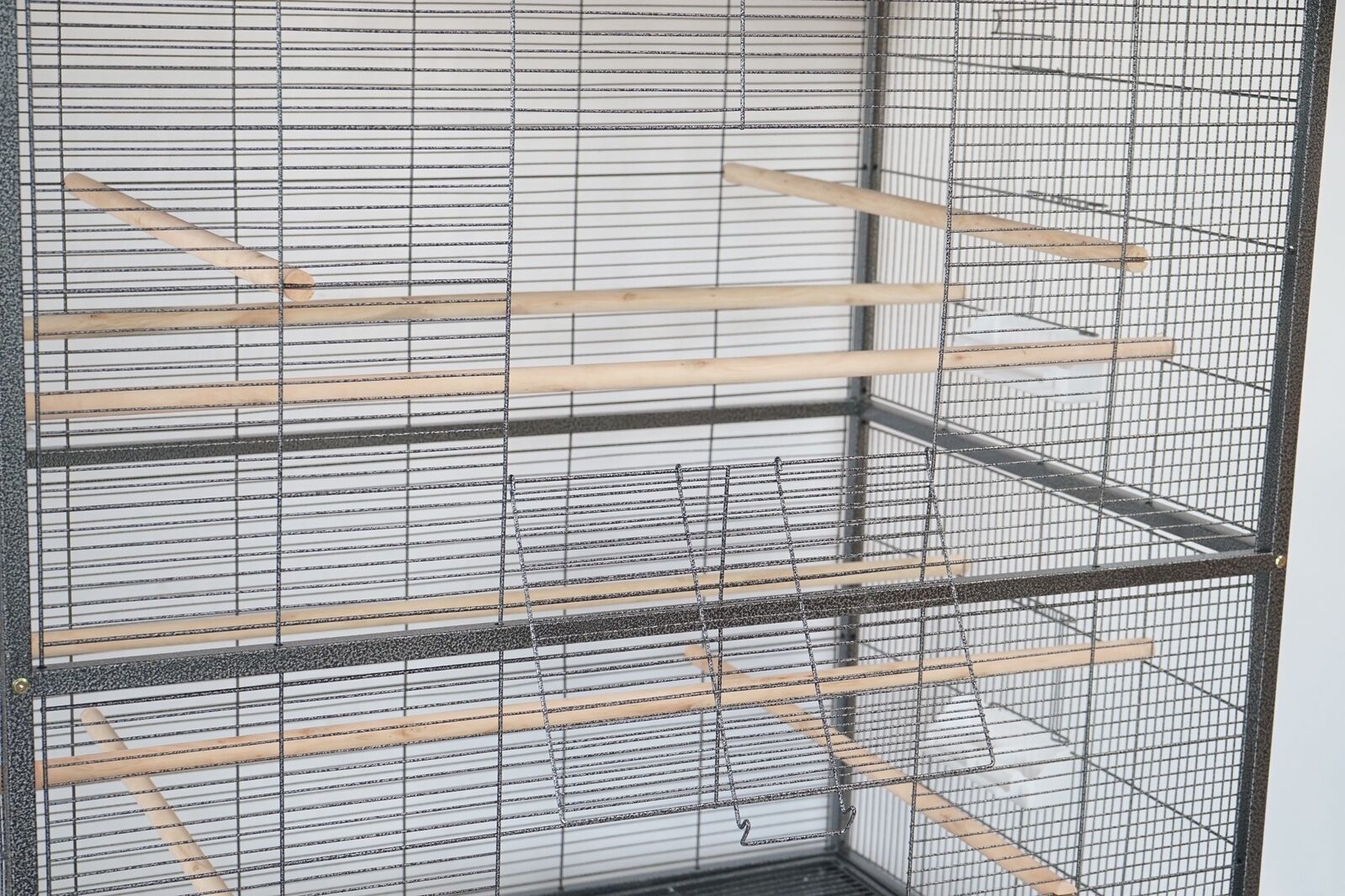 Large bird cage with wooden perches on a white background at Pet Servo