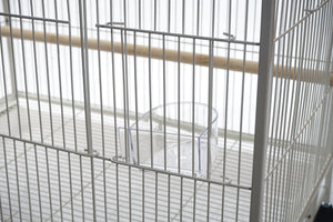 Bird cage with a clear plastic dish inside, on a white background at Pet Servo