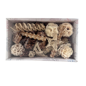 Decorative items including flowers and ribbons in a box on a white background