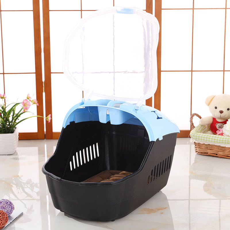 Pet carrier with a blue top on a light wooden floor at Pet Servo