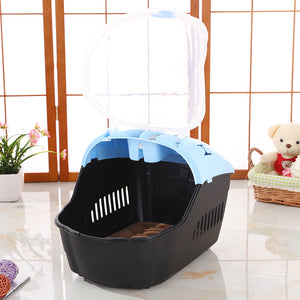 Pet carrier with a blue top on a light wooden floor at Pet Servo
