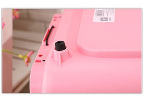 Close-up of a pink object with a black cap and label on a blurred background at Pet Servo