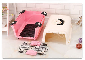 Pink and white pet crates with accessories on a light wooden floor at Pet Servo