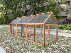 Wooden greenhouse on a stone path with trees and a building in the background at Pet Servo