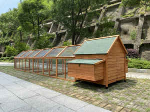 Wooden chicken coop with glass panels in a garden setting at Pet Servo