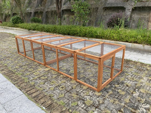 Wooden bird cage on a stone pavement with greenery in the background at Pet Servo