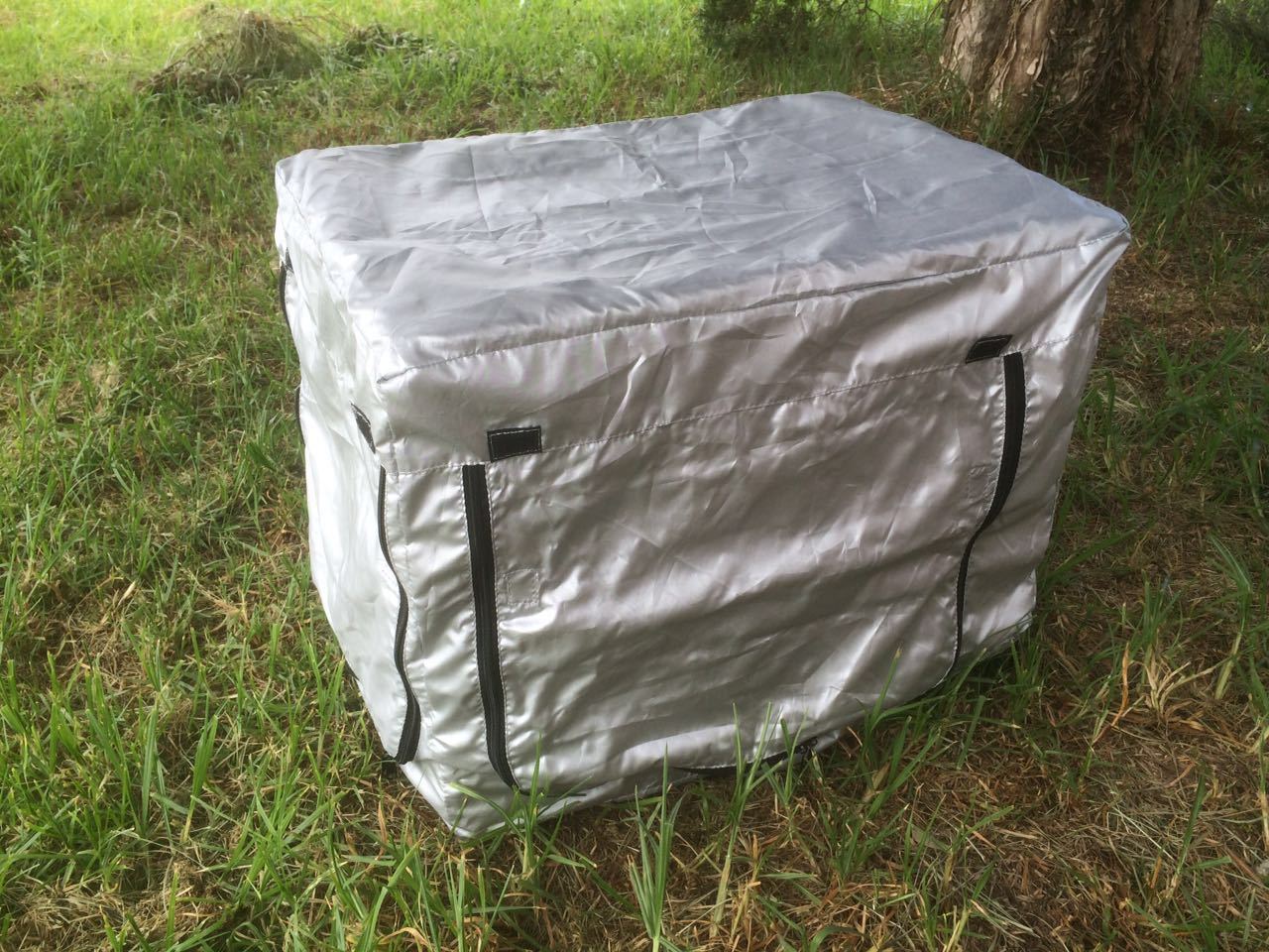 Silver storage box with black straps on grass at Pet Servo