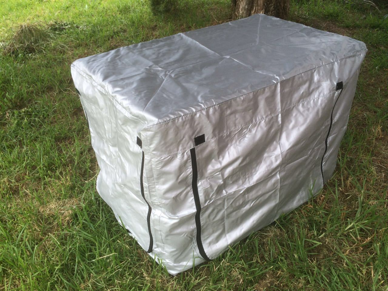 White storage bin with black zippers on a grassy ground at Pet Servo