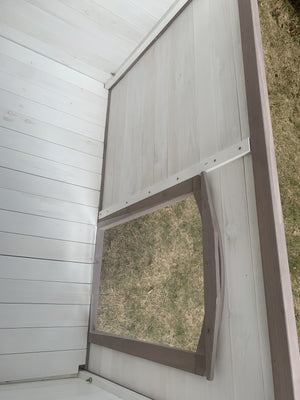 Screened window on a wooden structure with grass outside at Pet Servo