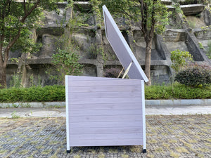 White outdoor trash bin with a lid in a park setting at Pet Servo
