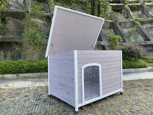 Wooden pet house with a brown roof on a stone pavement at Pet Servo