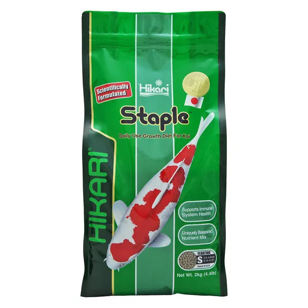 Green package of Hikari Staple fish food with a koi fish illustration on a white background at Pet Servo