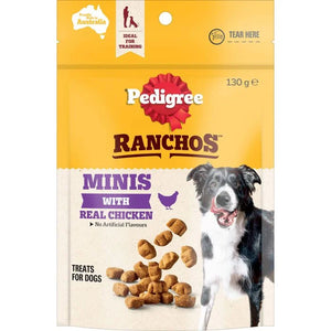 Pedigree Ranchos Minis with Real Chicken dog treats in a 130 g resealable pouch. The packaging features a bright yellow top half, a cream lower half, a red Pedigree logo, and a photo of a black and white dog next to several brown kibble pieces.