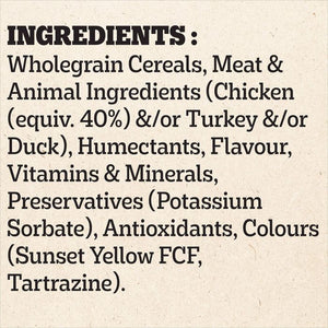A text panel on a light beige textured background listing ingredients, including wholegrain cereals, meat and animal ingredients such as chicken and turkey, humectants, flavour, vitamins & minerals, preservatives, and antioxidants like Sunset Yellow FCF and Tartrazine.