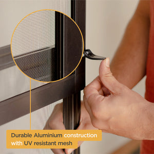Person installing a screen door with durable aluminium construction and UV resistant mesh.