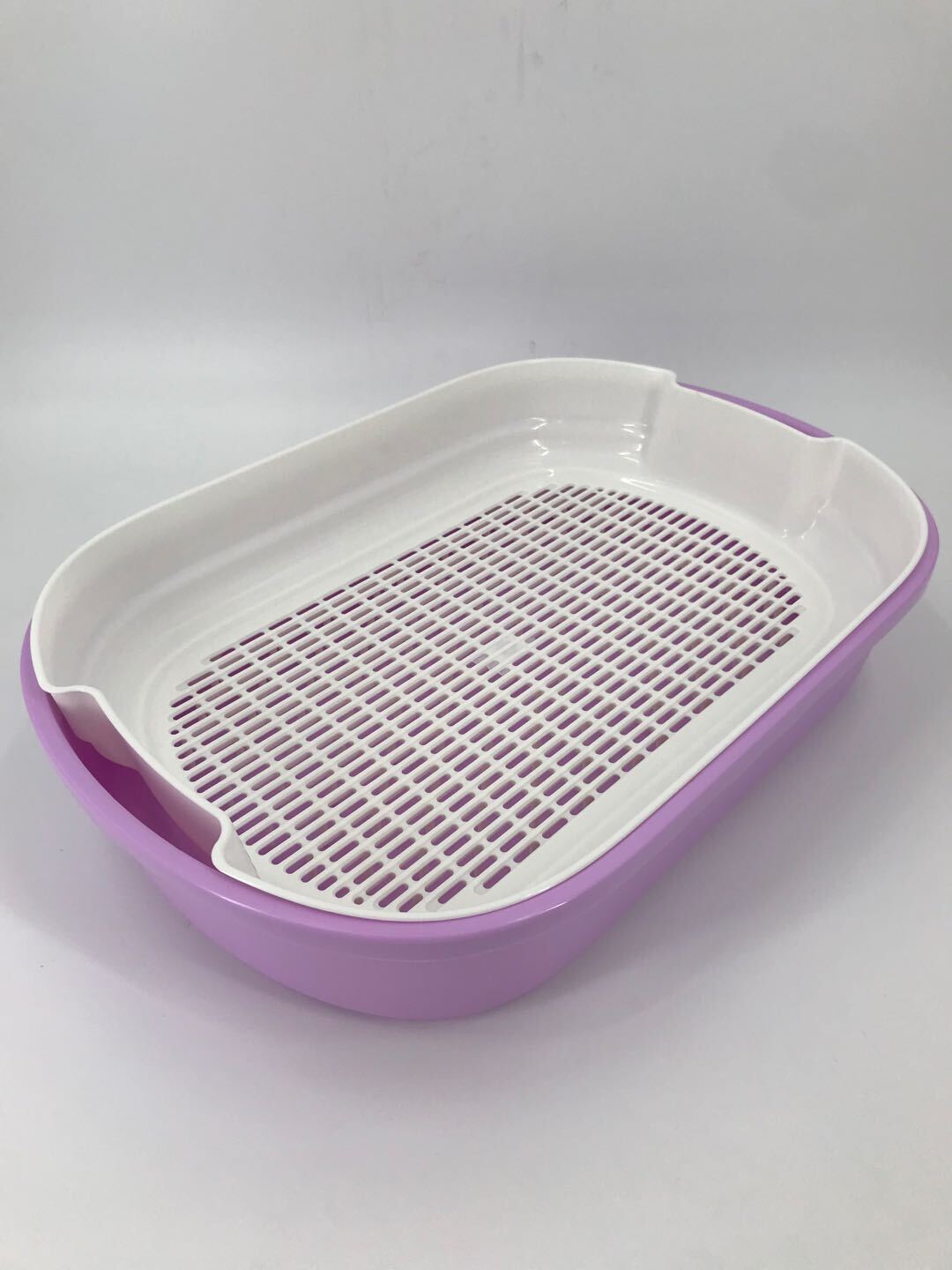 Purple and white pet litter pan on a gray background at Pet Servo