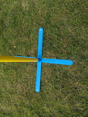 Blue crossbar with yellow pole on grass at Pet Servo