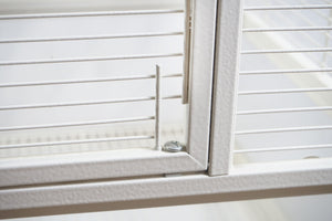 Window with white blinds on a white background at Pet Servo