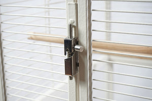 Birdcage with a wooden perch and metal latch on a white background at Pet Servo