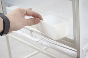 Hand reaching into a refrigerator drawer at Pet Servo