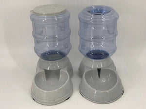 Two gray pet feeders with blue water bottles attached on a white background at Pet Servo