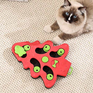 Cat playing with a red and green cat toy on a carpeted floor at Pet Servo
