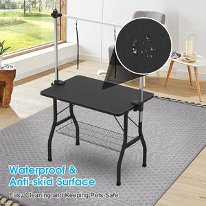 Black pet grooming table with waterproof and anti-skid surface in a home setting.