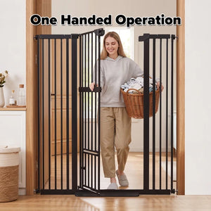 A woman walks through a black metal one-handed pet gate in a home setting, holding a wicker basket of laundry. The text 'One Handed Operation' is displayed at the top of the image at Pet Servo