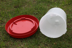 Red and white plastic containers on grass at Pet Servo