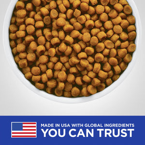 White bowl filled with orange pet food on a white background, with a 'Made in USA with Global Ingredients' label at the bottom.