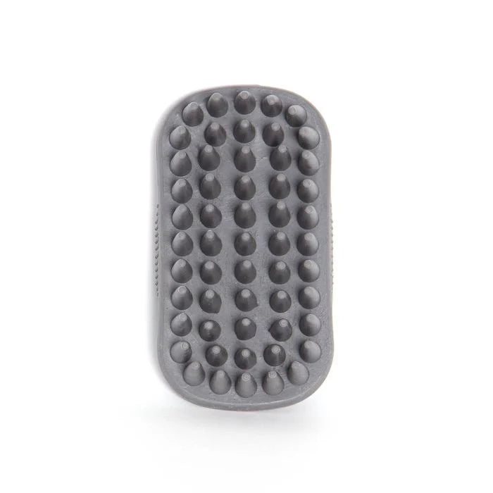 A dark gray silicone massage brush with rounded rectangular edges and rows of raised dome-shaped nubs, shown on a clean white background.