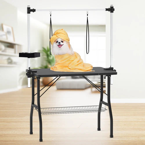 Dog draped in a yellow towel on a grooming table with a white background at Pet Servo