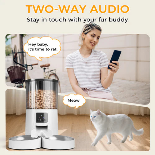 Woman using a smartphone with a pet feeder and cat in a home setting, emphasizing two-way audio feature at Pet Servo