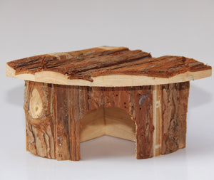 Wooden fairy house with a textured roof on a white background at Pet Servo