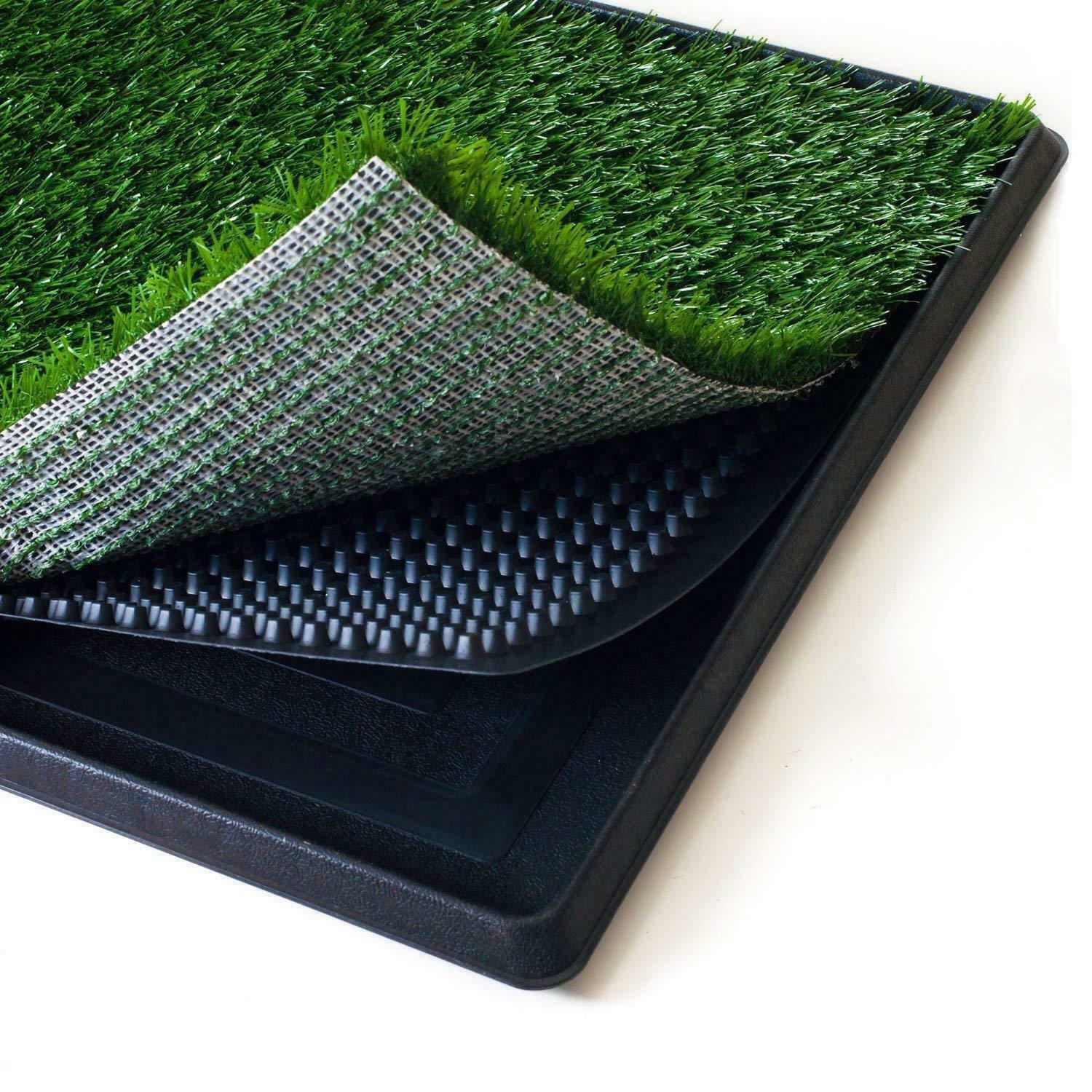 Roll of artificial grass with a textured black mat on a white background at Pet Servo