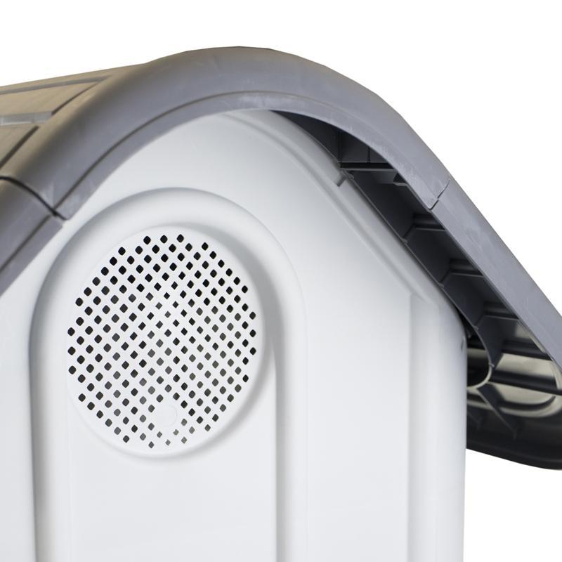 Close-up of a white and gray electronic device with a speaker grille at Pet Servo