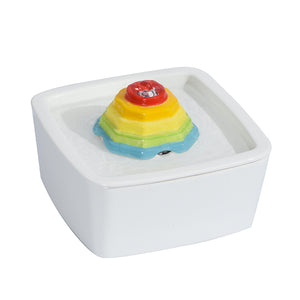 Colorful layered object on a white base with a white background at Pet Servo