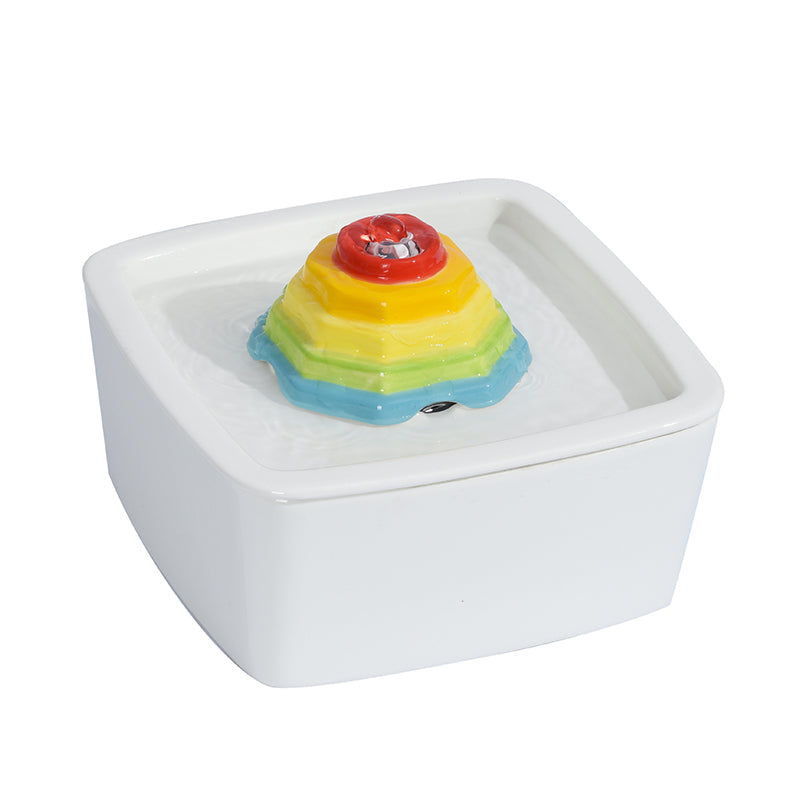 Colorful layered object on a white base with a white background at Pet Servo