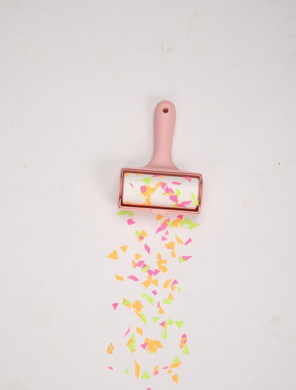 Pink roller with colorful confetti on a light gray background at Pet Servo