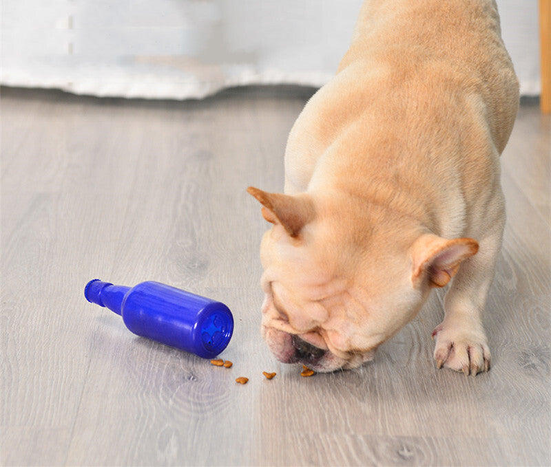 Dog interacting with a blue bottle on a wooden floor at Pet Servo